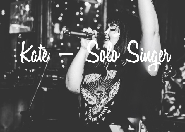 A woman sings into a microphone with her arm raised. Text overlay reads: "Kate - Solo Singer." The setting is dimly lit with decorative lights in the background.